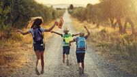 Three kids running on last day of school