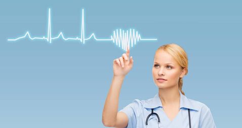 iStock-461233329(1).jpg female doctor or nurse pointing to cardiogram