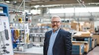 IPC_iStock-1540210279.jpg Efficient Factory Management: Portrait of Smiling Senior Manager Businessman or CEO in Industrial Factory Warehouse