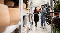ISTOCK-2189803626.jpg Saleswoman Assisting Man in Choosing Decorative Flower Pots