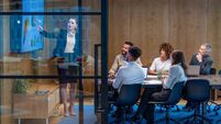 iStock-1484954545.jpg Woman giving a big data presentation on a tv in a board room.
