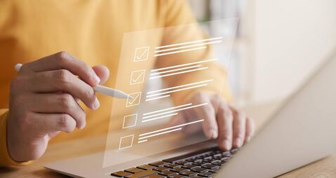CAO3_iStock-1467350162.jpg Business performance checklist concept, businessman using laptop doing online checklist survey, filling out digital form checkli