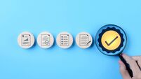 iStock-2156677072 (1).jpg Quality Control and Certification Assurance Concept. Hand holding magnifying glass over checkmark symbol, alongside icons repres