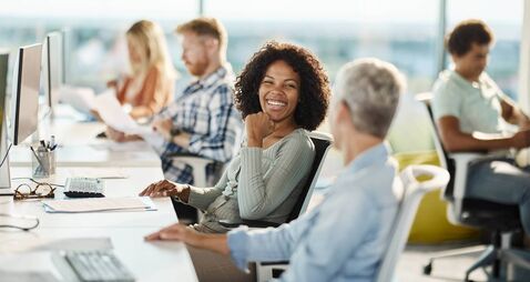 iStock-1437820671 (1).jpg Happy programmers talking while working in the office.