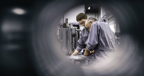 iStock-1164781482.jpg Engineers fixing a machine