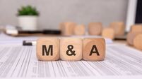 Acquisitions - iStock-2201814990.jpg wooden blocks with 'M and A' letters on financial documents, symbolizing mergers and acquisitions