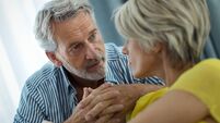 Middle aged couple having a conversation at home.