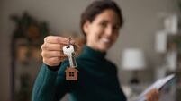 iStock-1335296835.jpg Close up focus on keys, smiling woman Real Estate Agent selling apartment