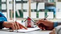 iStock-1343559279.jpg Customers interested in buying a home sign a signature to enter into a home purchase contract with a real estate agent. Mortgage