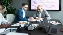 Mercer_iStock-2205049493.jpg Business professionals analyzing data in a meeting with charts and reports displayed