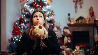 Broke Woman Holding a Piggy Bank Regretting Christmas Spendings