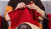 Handwork concept, young woman is knitting a needlework.