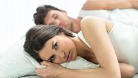 Worried couple in bed