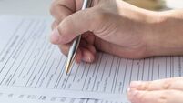 Applicant filling in company application form document applying for job, or registering claim for health insurance
