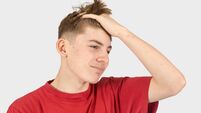 Headshot of an annoyed teenage boy