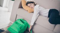 Photo of cute tired sleepy boy pupil sleeping lying soft divan after school lesson apartment room interior indoors