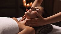 Attractive woman enjoying face massage, closeup. Beauty procedure