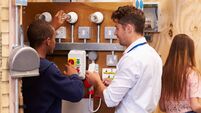 iStock-510616831.jpg Teacher Helping Students Training To Be Electricians