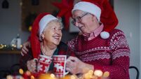 Happy senior couple celebrating Christmas Eve together.