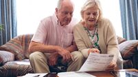 Couple discussing over medical bill  while sitting on sofa