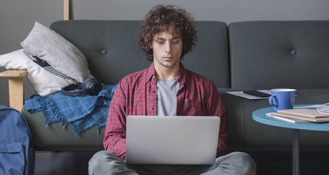 iStock-1227031493.jpg Learning and Studying from Home: a Diligent College Student Attending an Online Course by Using his Laptop Computer