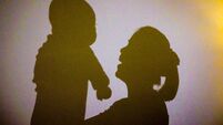 Shadow Of Mother Holding Baby On Wall