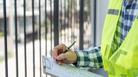 inspector or engineer is inspecting construction and quality assurance new house using a checklist. Engineers or architects or c