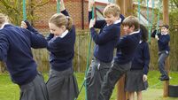 Elementary School Pupils On Climbing Equipment