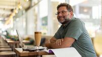 Mature man in cafe using laptop