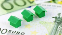 Green model houses and banknotes