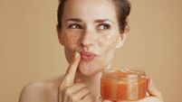 happy modern woman with face scrub