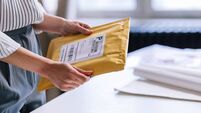 An Unrecognizable Businesswoman Preparing A Package For Shipping