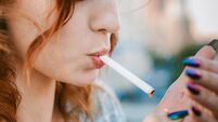 Close-Up Of Woman Burning Cigarette