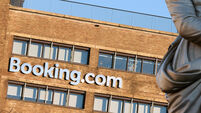 Booking.com HQ headquarters head office building on the Rembrandtplein Rembrandt Square with the statue of Rembrandt. Amsterdam.