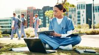 Woman, nurse or student writing with book for internship, studying or research at med school. Female person, healthcare candidat