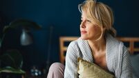 Portrait of a Beautiful Woman Sitting on Her Bed in the Morning
